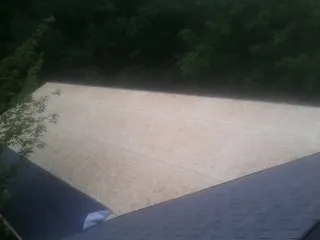 New OSB roof sheathing installed beside an existing shingle roof in Tennessee Ridge