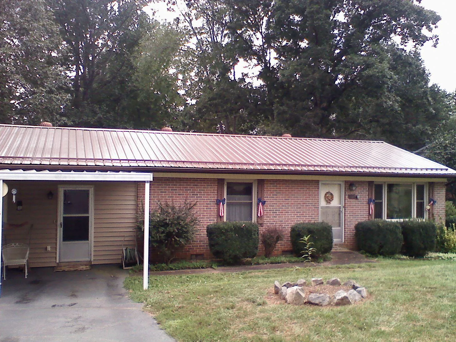 Bronze metal roof and carport on a brick ranch home — Roof Repair work by our crew in Tennessee Ridge